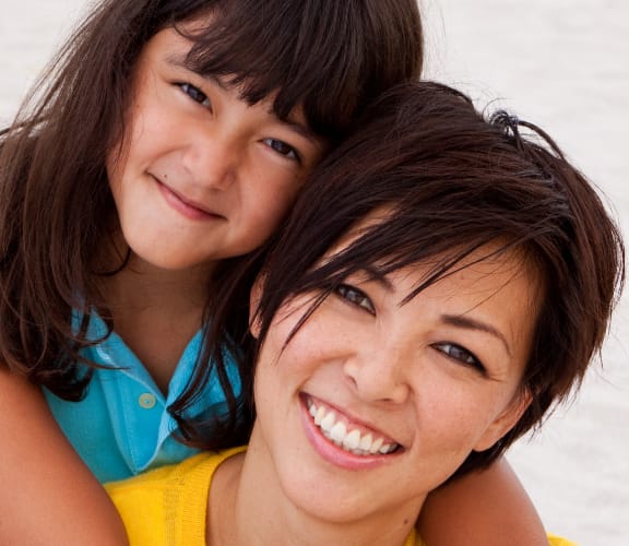 Mom with her daughter on her back