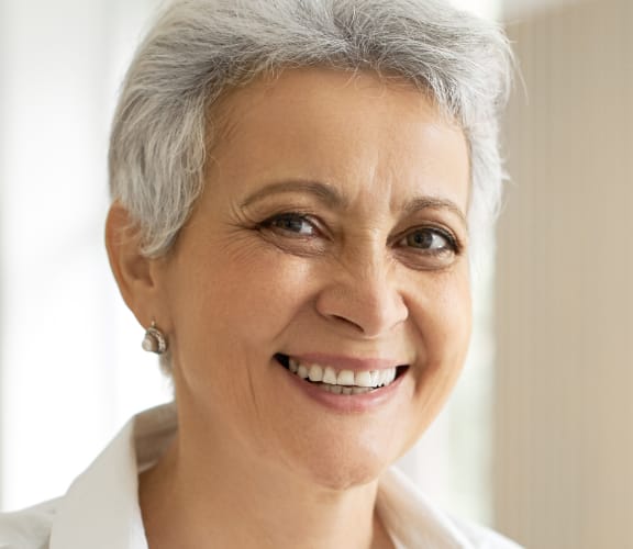 Mature woman sitting at her desk on the computer