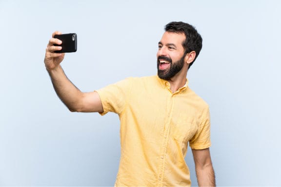 Man taking a selfie with a mouth opened smile